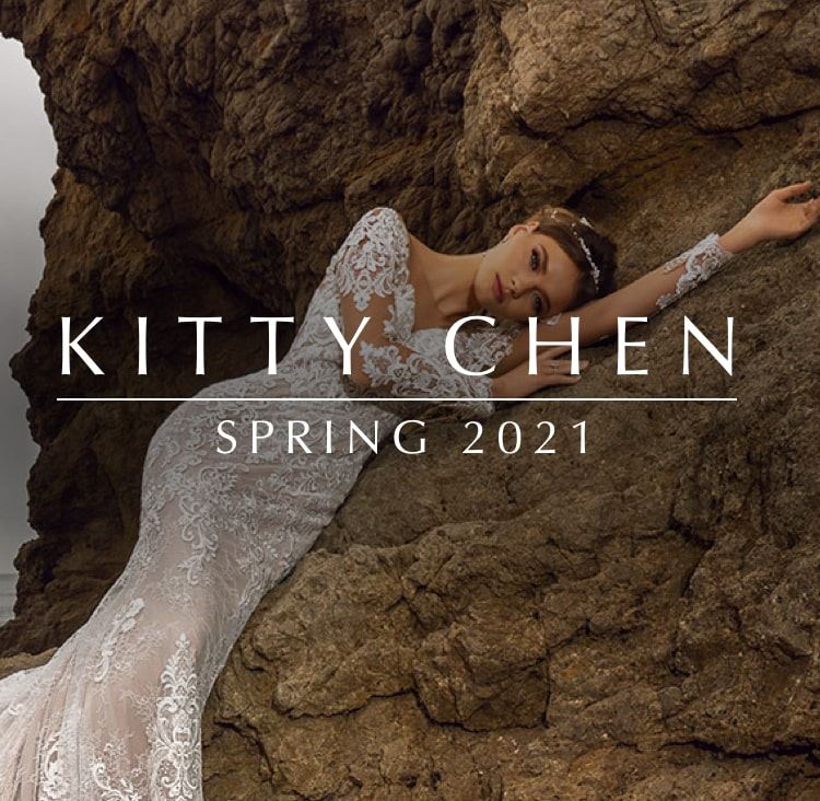 Model wearing a lace Kitty Chen wedding gown at the beach